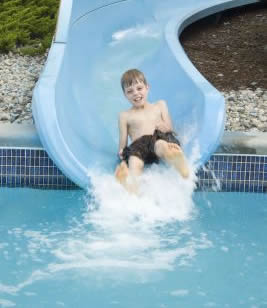 Children enjoying an outdoor swimming pool at a holiday park